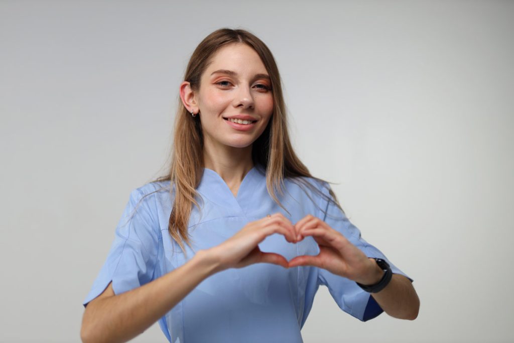 Practitioner making heart sign with hands