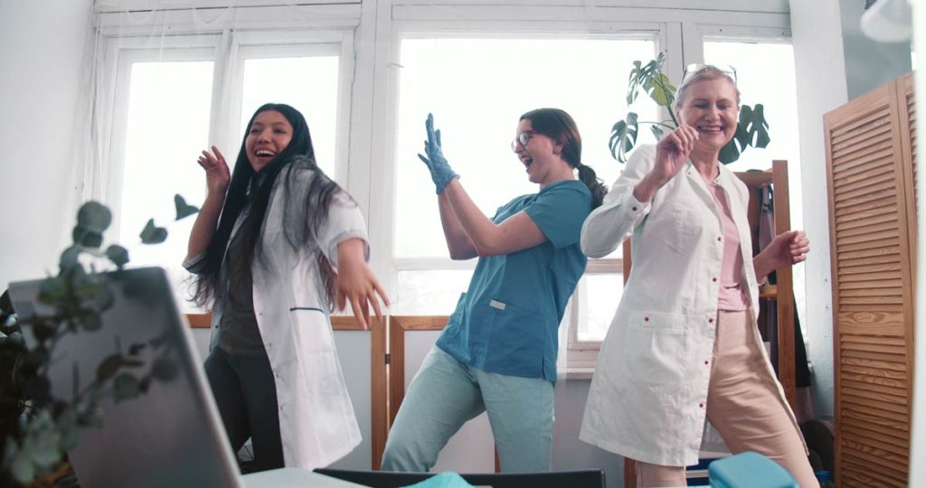 Medical practitioners dancing at a clinic